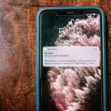 Alert message about transaction verification from bank on mobile phone.