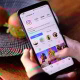 Instagram app on smartphone showing profile with followers and posts.