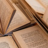 Open books with pages for reading and writing in the image.