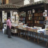 Art and book stalls on the street showcasing vintage books, artwork, and collectibles.