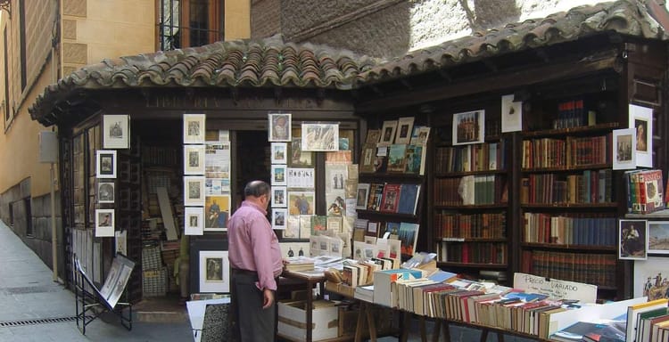 Art and book stalls on the street showcasing vintage books, artwork, and collectibles.