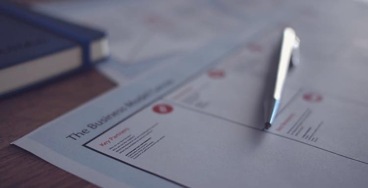 Close-up of a word count sheet with pen and documents, emphasizing the importance of word counting for content writing and editing.