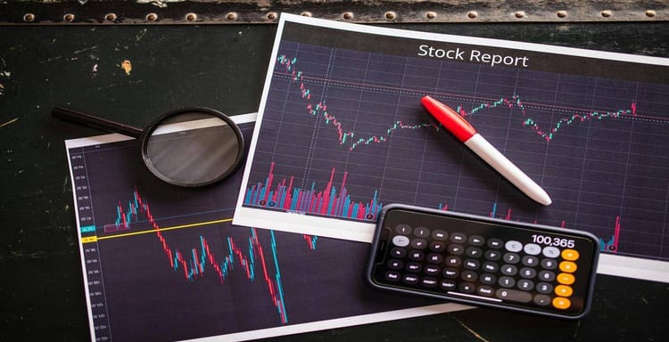 Stock market analysis with financial charts and a calculator for investment insights.