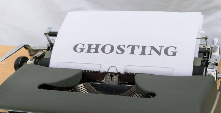 Typewriter with "GHOSTING" text on paper, symbolizing ghosting effects in digital displays.