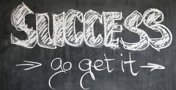Chalkboard with "Success" and "go get it" motivational quote in white chalk.