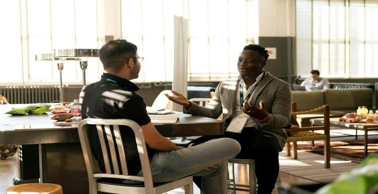 Optimized for productivity and collaboration, two professionals engage in a meaningful conversation in a bright modern office.