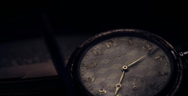 Old-fashioned pocket watch with aged dial, vintage style, and classic appearance.