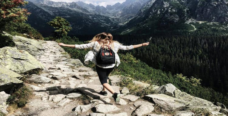 Enjoying mountain trail hike with scenic views and nature adventure.