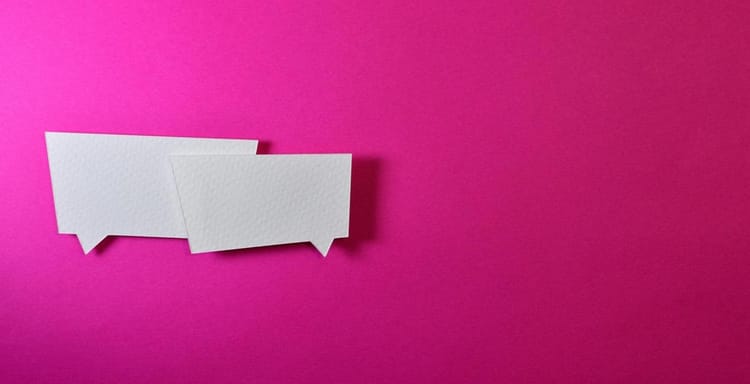 Speech bubbles for word count or text analysis on pink background.