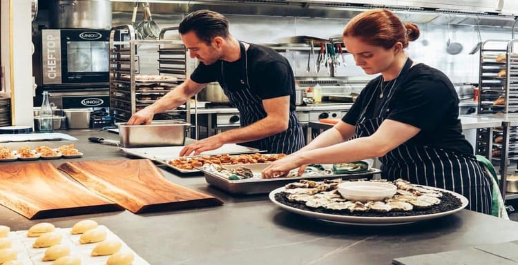 Alt: Chefs preparing food in a professional kitchen for accurate word counting and productivity.
