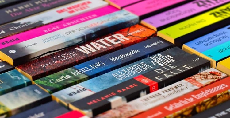 Compact image of colorful book spines with titles, highlighting reading and literature themes.