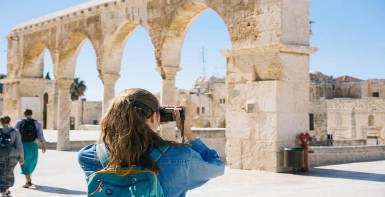 Historic arches in a sunny archaeological site.
