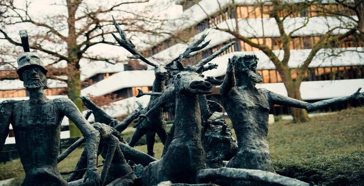 Highly detailed bronze sculptures of mythological figures and warrior statues outdoors.