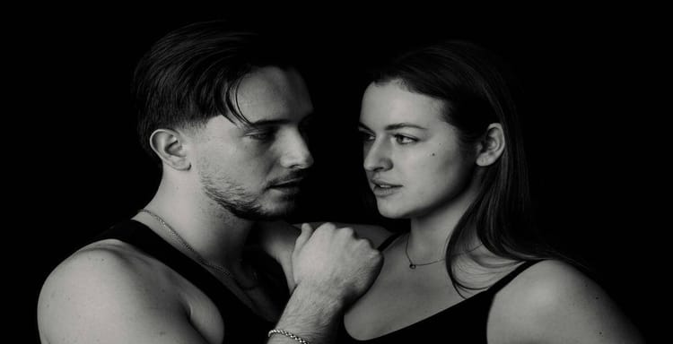 Close-up of a romantic couple in black and white, emphasizing love and connection.