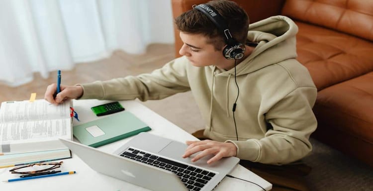 Wireless headphones with laptop for writing.