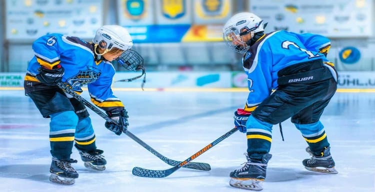 Young hockey players battling for puck.