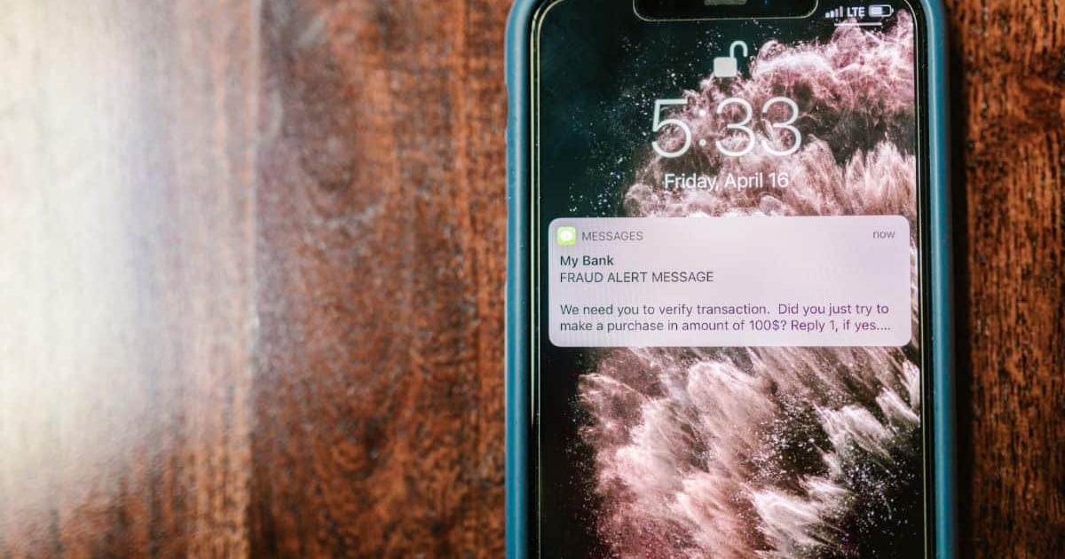 Alert message about transaction verification from bank on mobile phone.