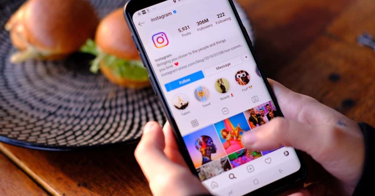 Instagram app on smartphone showing profile with followers and posts.