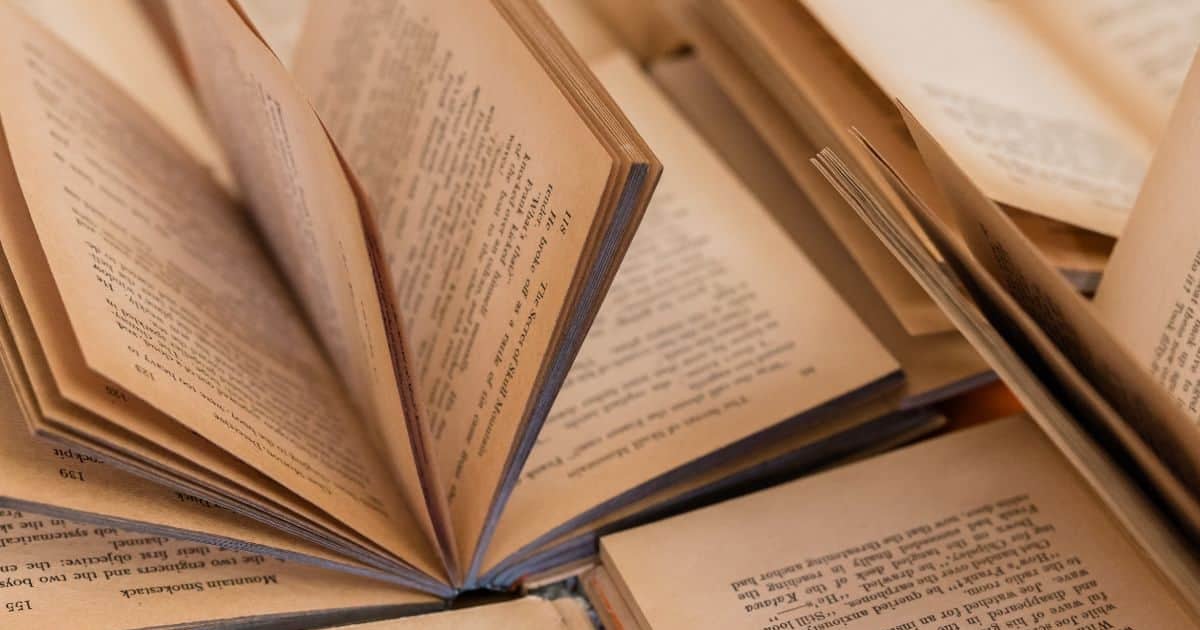 Open books with pages for reading and writing in the image.