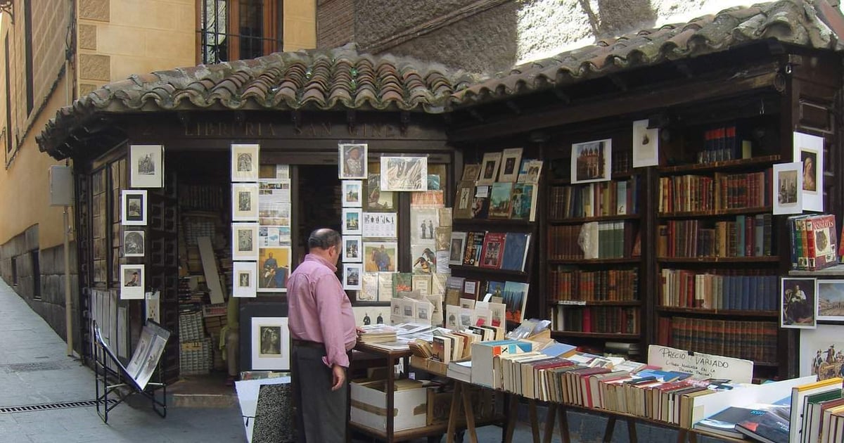 Art and book stalls on the street showcasing vintage books, artwork, and collectibles.