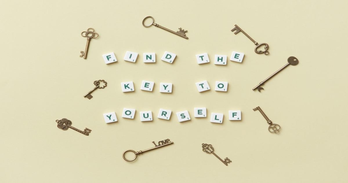 Keys and letter tiles spelling "Find the key to yourself" on a beige background.
