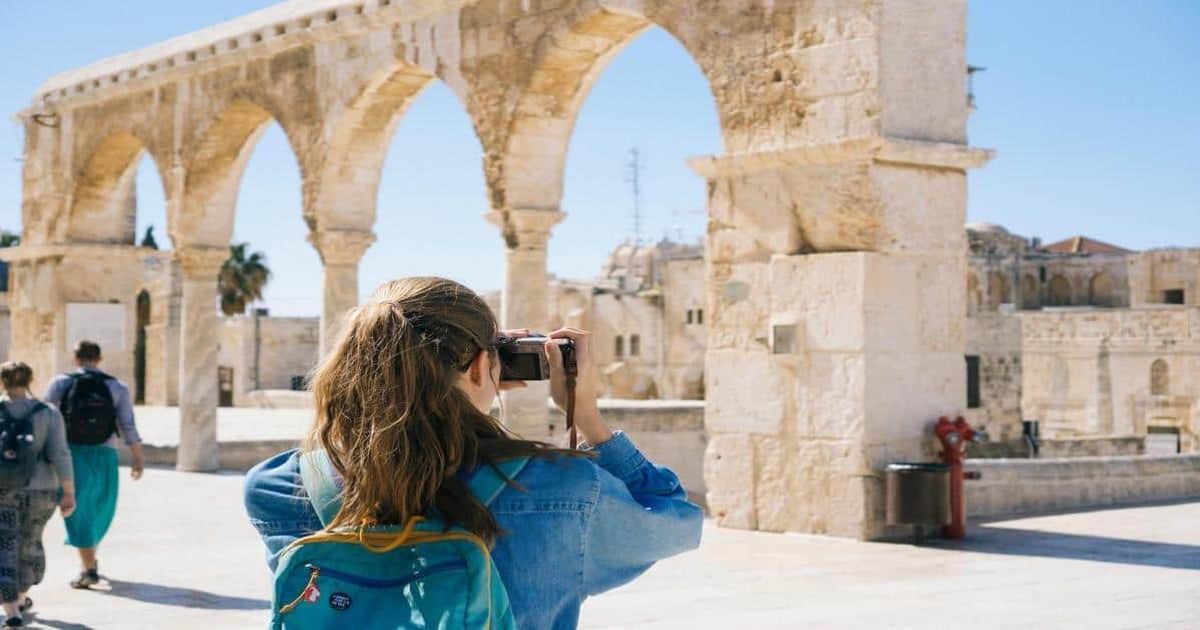 Historic arches in a sunny archaeological site.