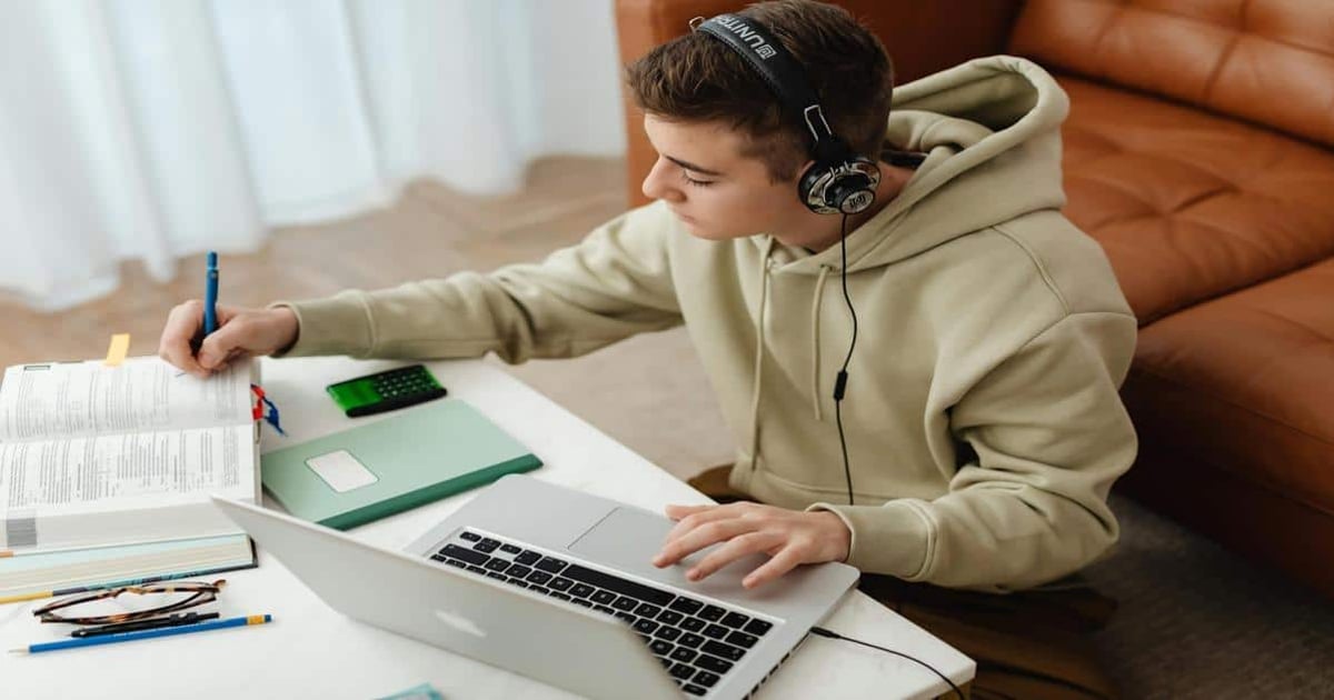 Wireless headphones with laptop for writing.